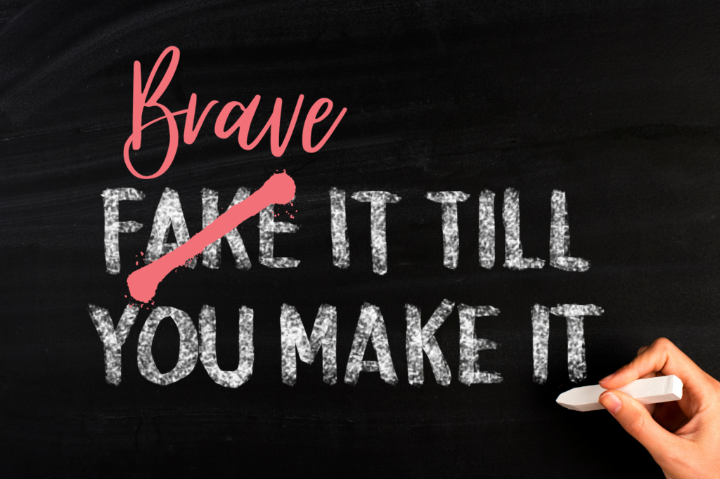 The words fake it till you make it written in chalk on a blackboard. The word fake is crossed out with the word Brave above, making it Brave it till you make it.