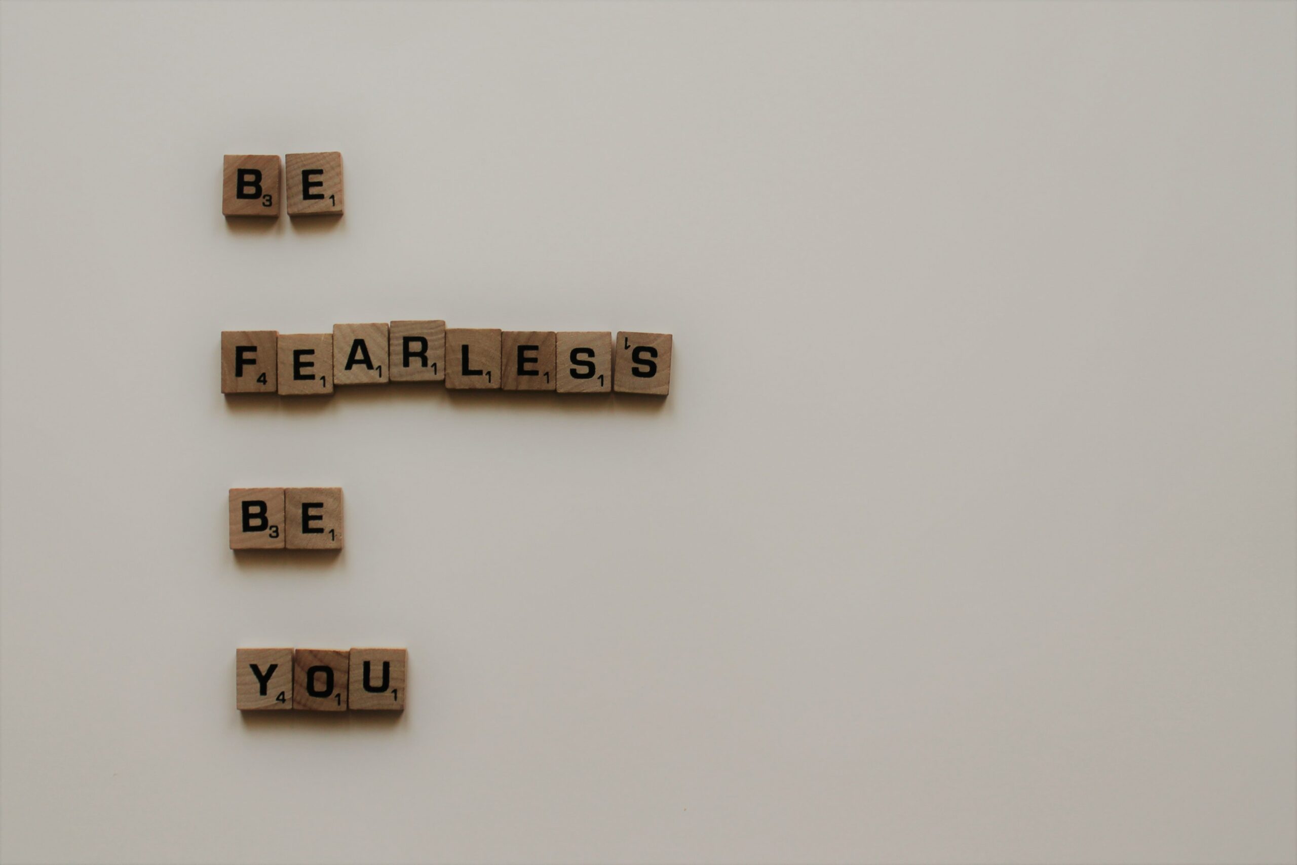 Text reads "Be Fearless Be You" in Scrabble tiles to represent how being your authentic self helps you to combat your Imposter Persona/s.